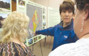 At a community meeting last week at The Manor, Heins Road resident Laurie Rossdentsher discusses with neighbors a map of a proposed residential development that they fear could adversely affect the tranquility of their rural properties. (Photo/Barbara Ball)
