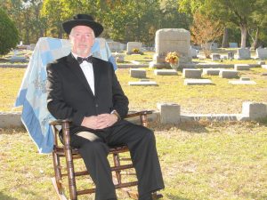 The gravestone of Blythewood founding father George P. Hoffman can be seen in the background as Town Councilman Eddie Baughman relates the story of the Hoffman House, built by Hoffman, which is now the Town Hall. (Photo/Barbara Ball)
